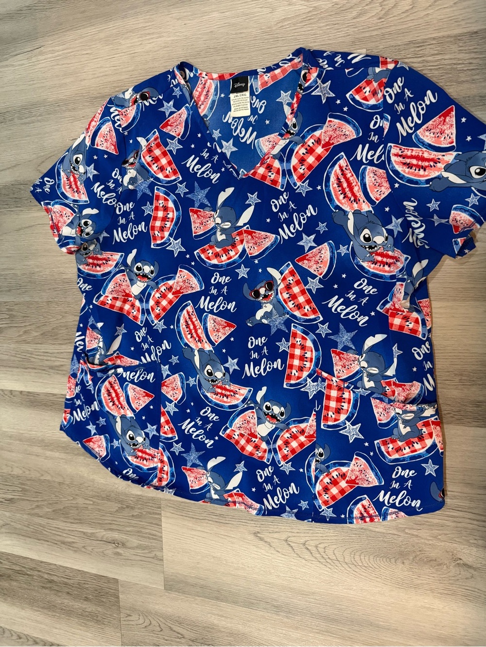Disney royal blue scrub top with red and white watermelon motif - Picture 1 of 3